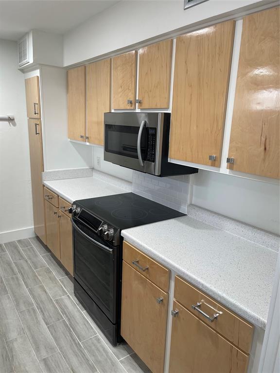 a kitchen with a stove microwave and sink