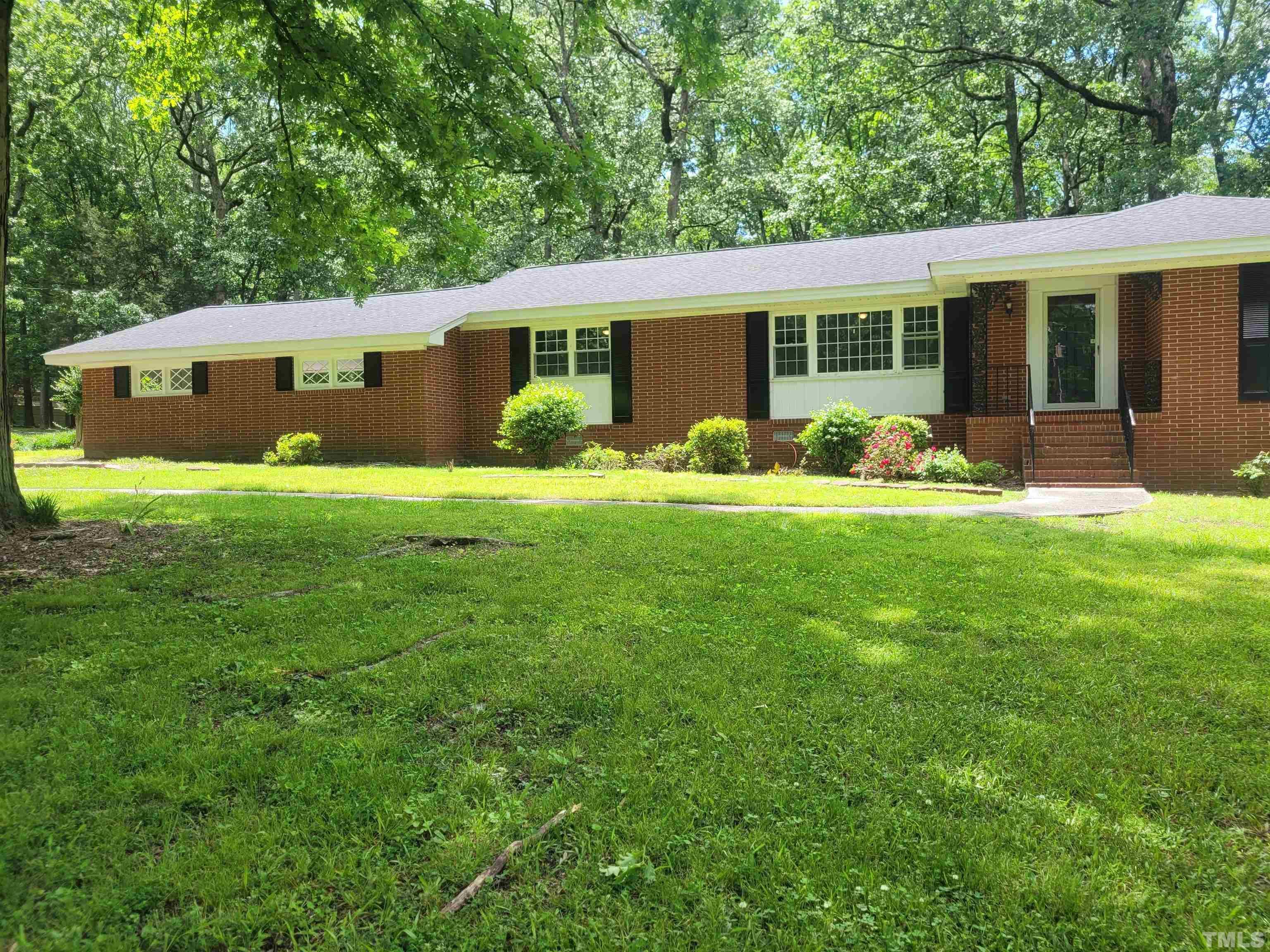 a front view of house with yard and green space