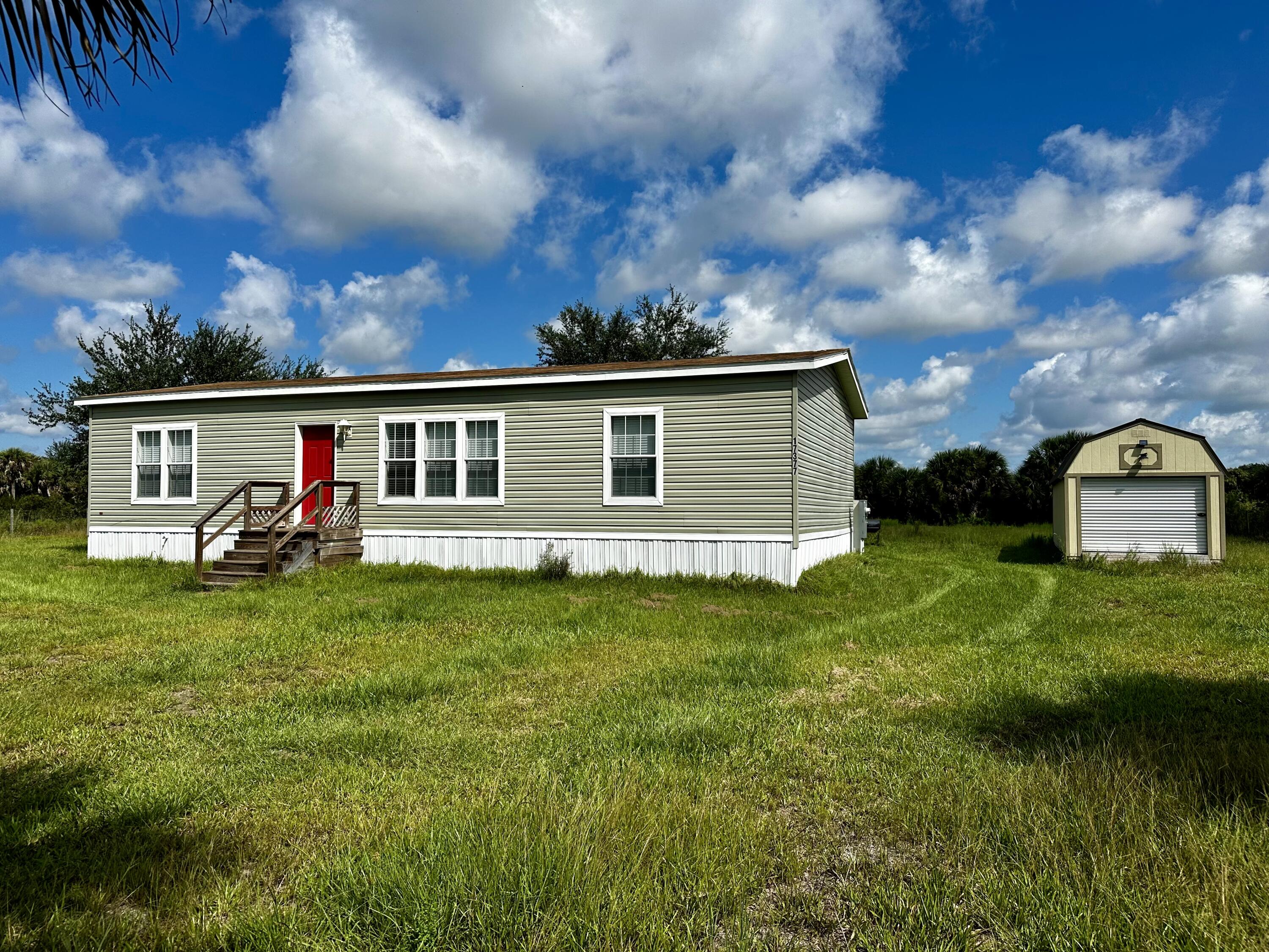 a view of a house with a yard and sitting area