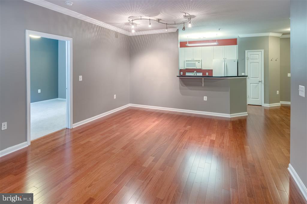 wooden floor in an empty room with a mirror