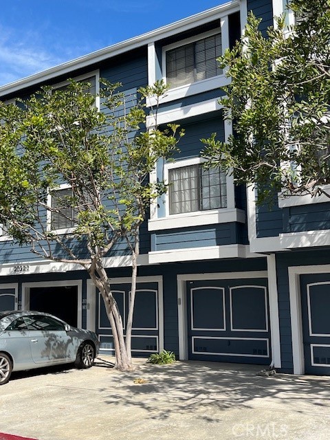 a front view of a house with parking space