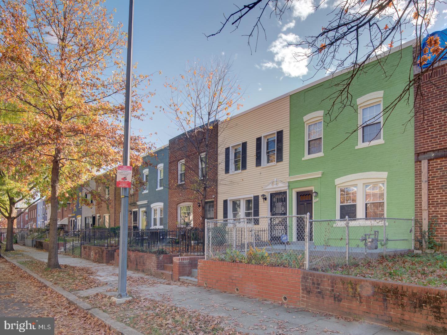 a view of a brick building next to a yard