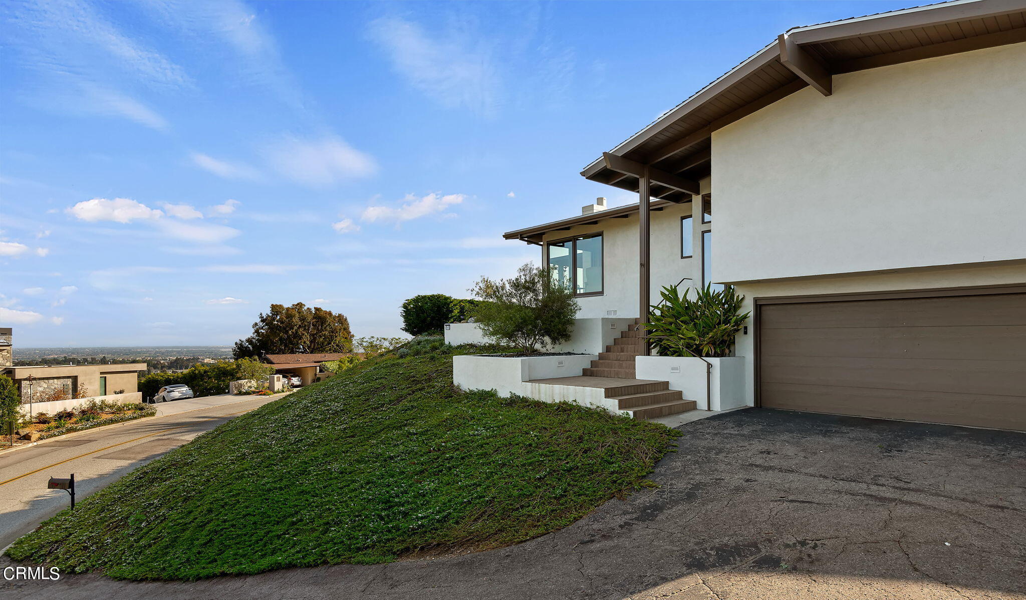 a view of a house with backyard and sitting area