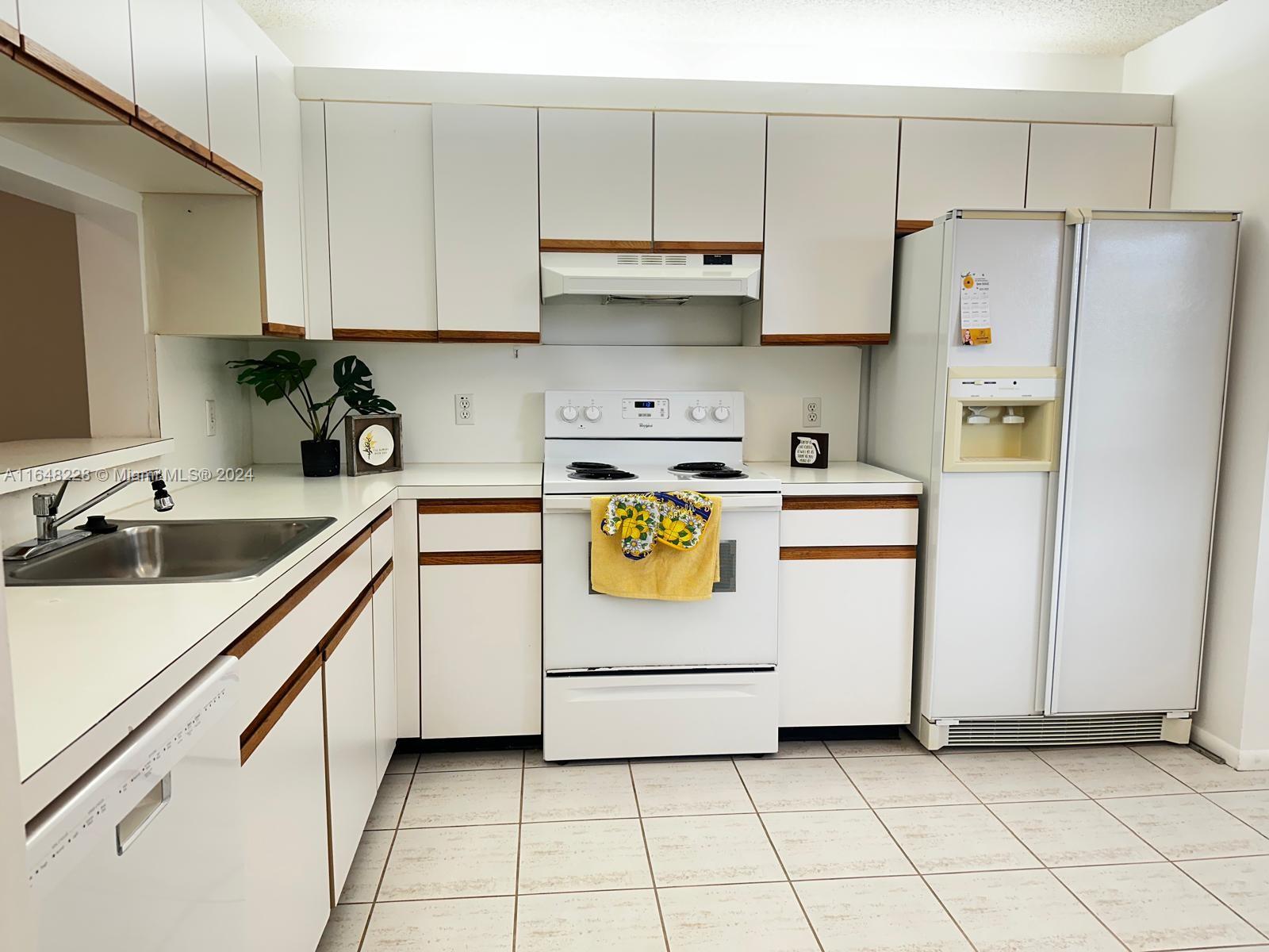 a kitchen with cabinets and white appliances