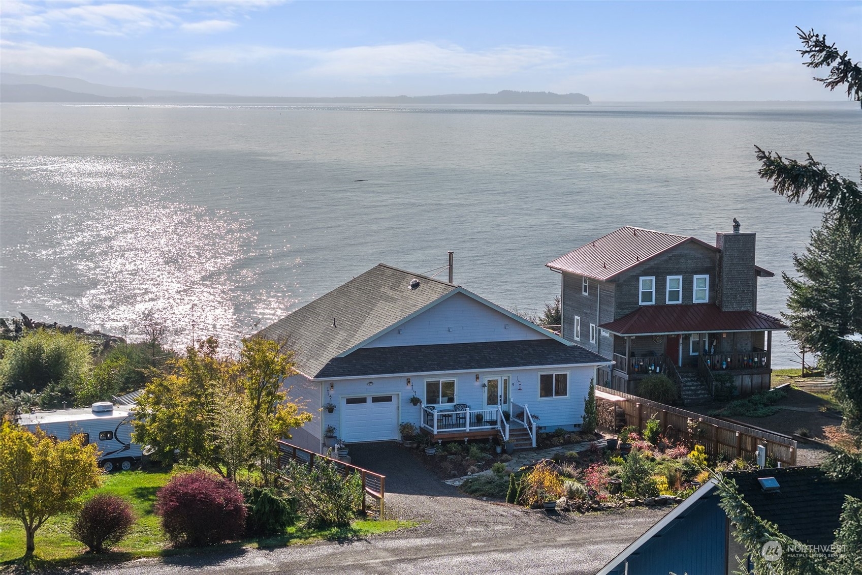 a front view of a house with lake view and a ocean view in back