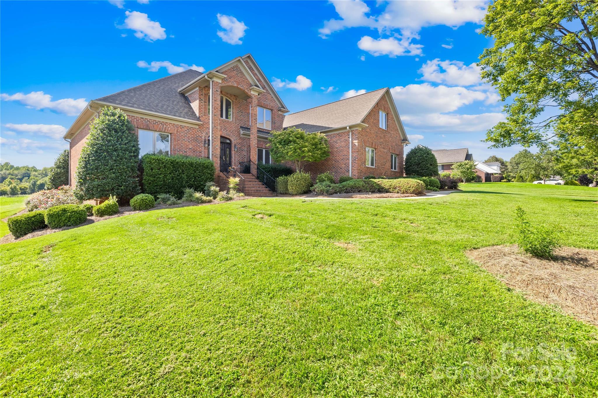 a front view of house with yard and green space