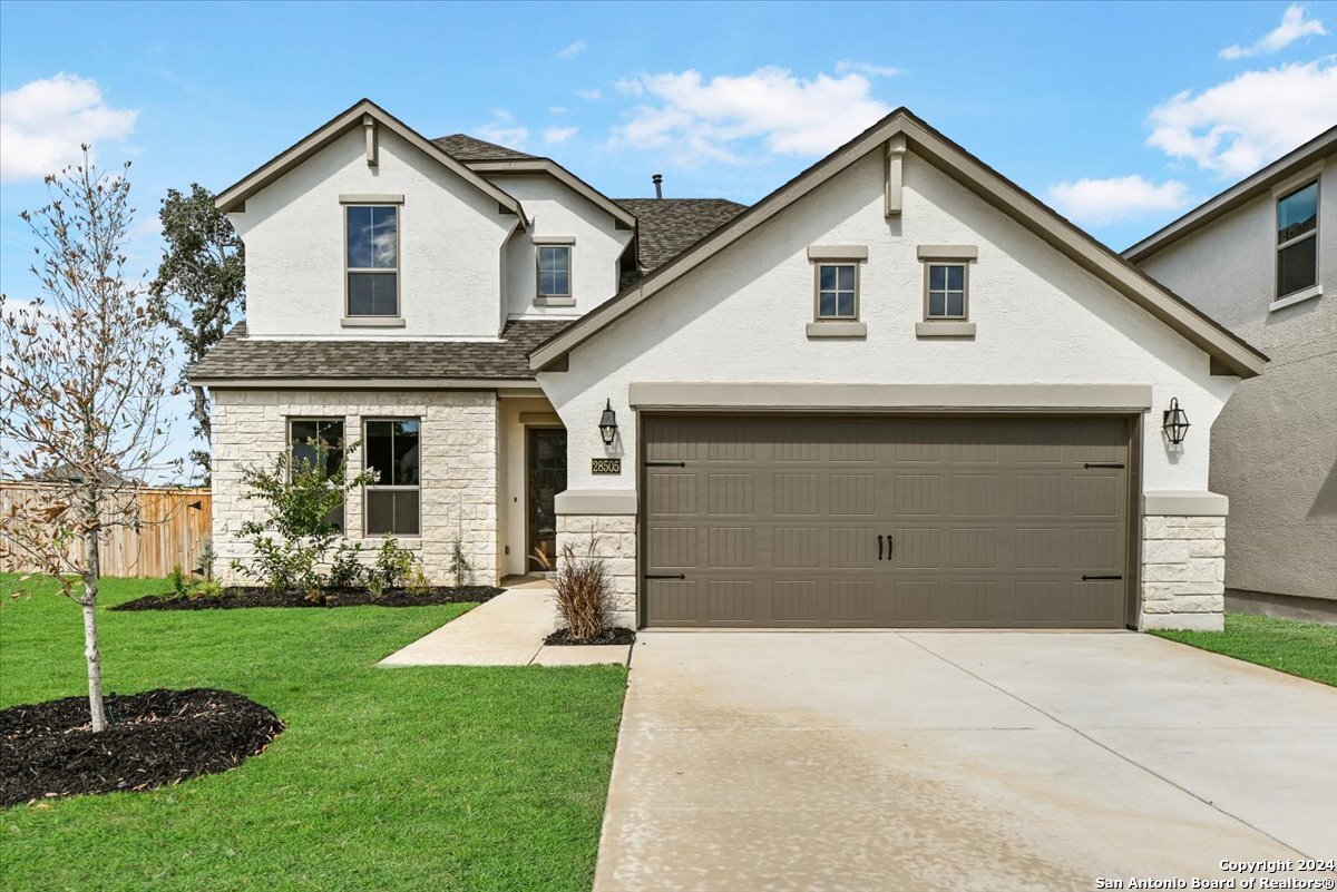 a front view of a house with garden