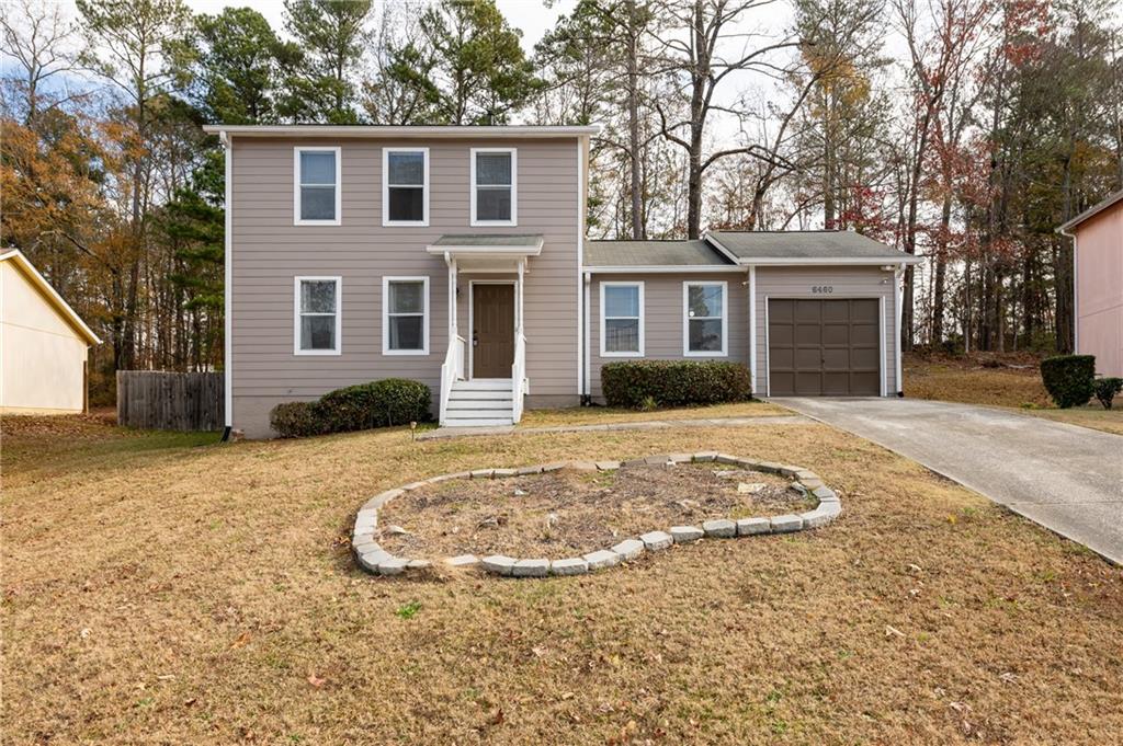 a front view of a house with a yard