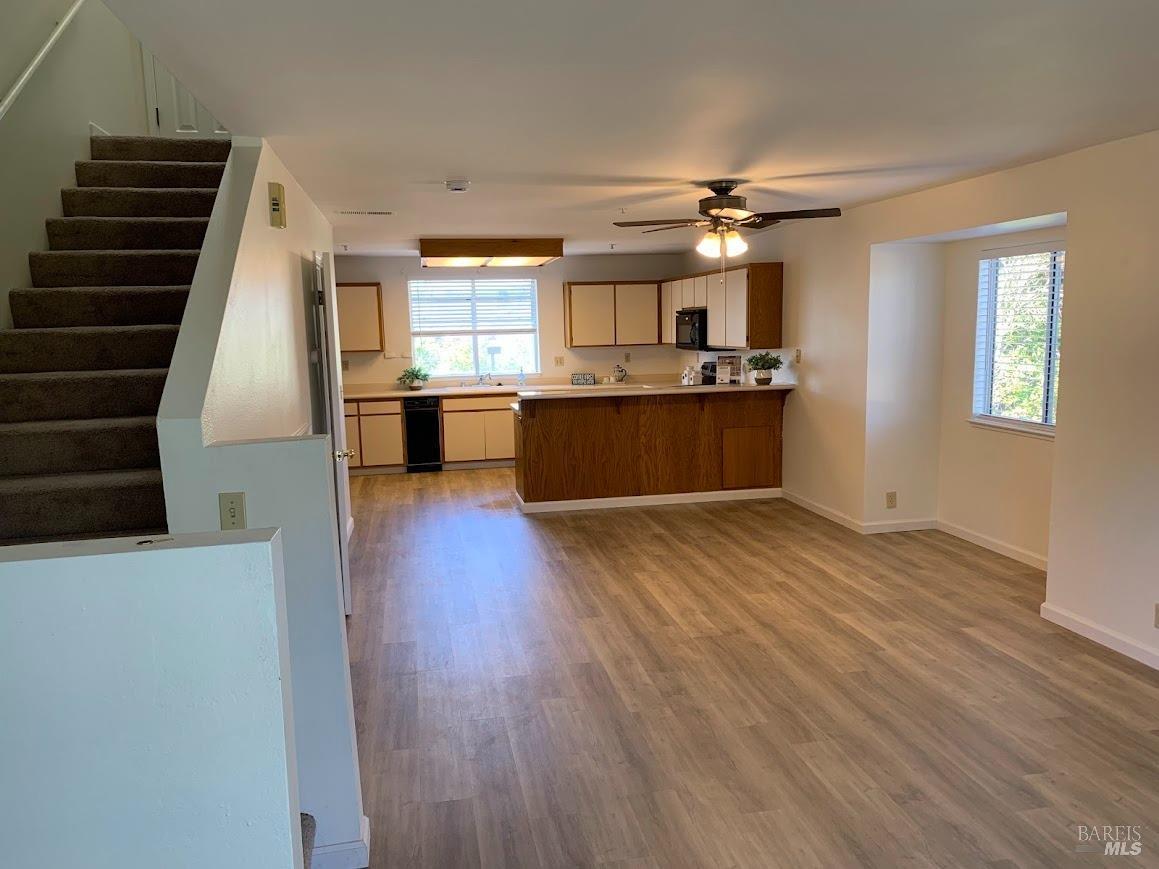 a view of kitchen and hall with wooden floor