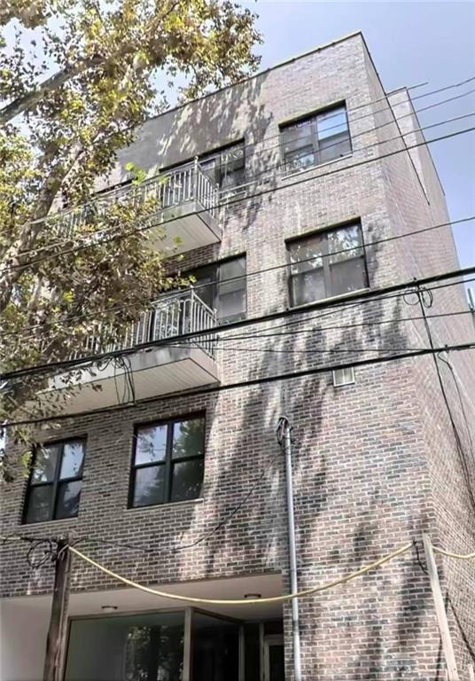 a view of a brick house with large windows