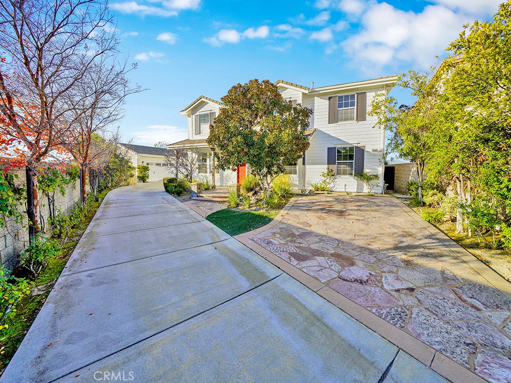 a pathway of a house with a yard