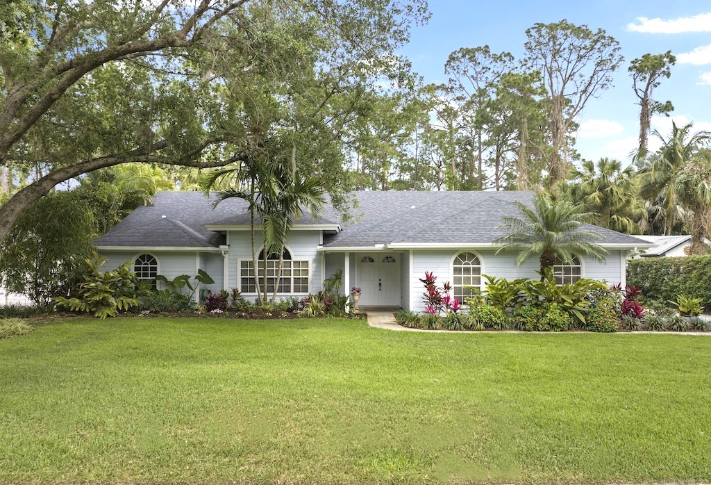 a front view of house with yard and green space