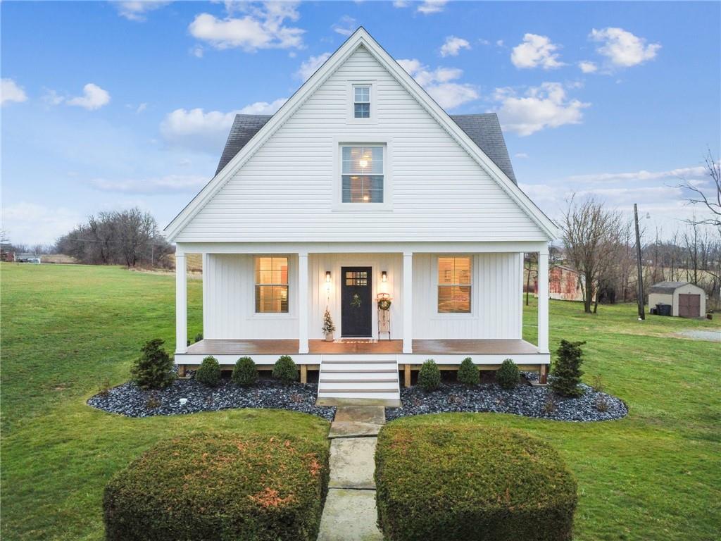 a front view of house with yard and green space