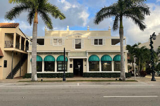 front view of house with a palm plants