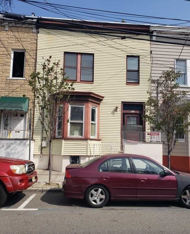 a front view of a house with parking space