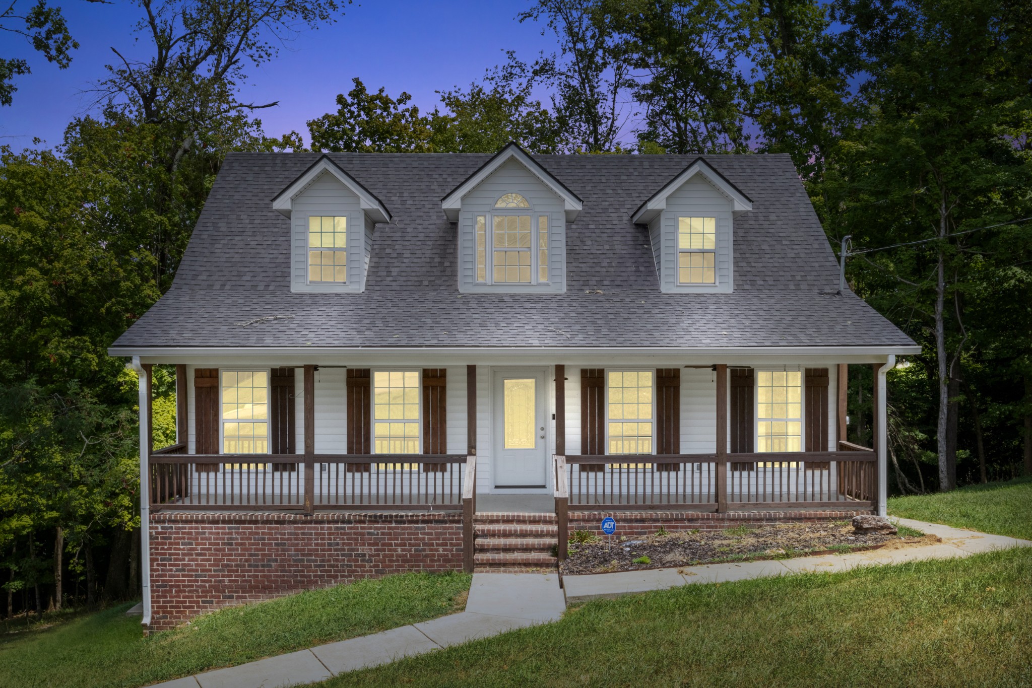 a front view of a house with a yard