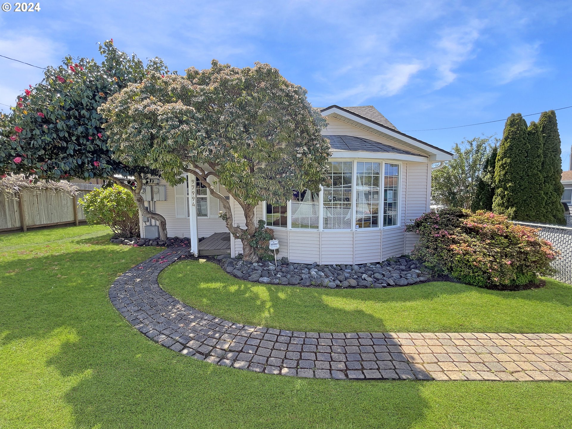 a front view of a house with a garden