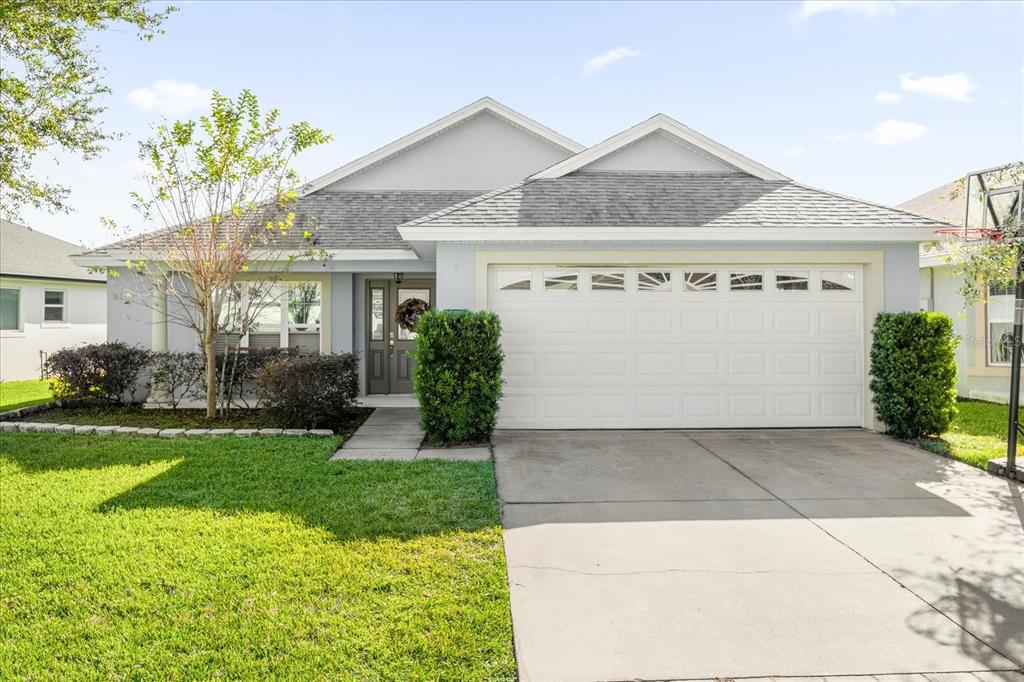 a front view of a house with a yard and garage