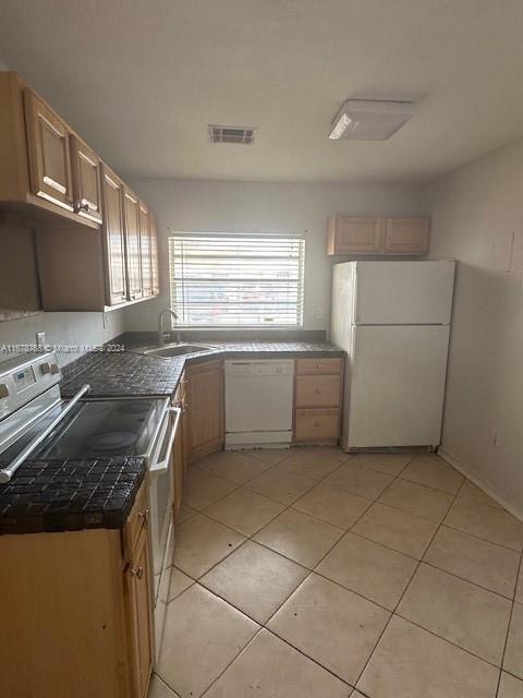 a kitchen with a stove a sink and a refrigerator