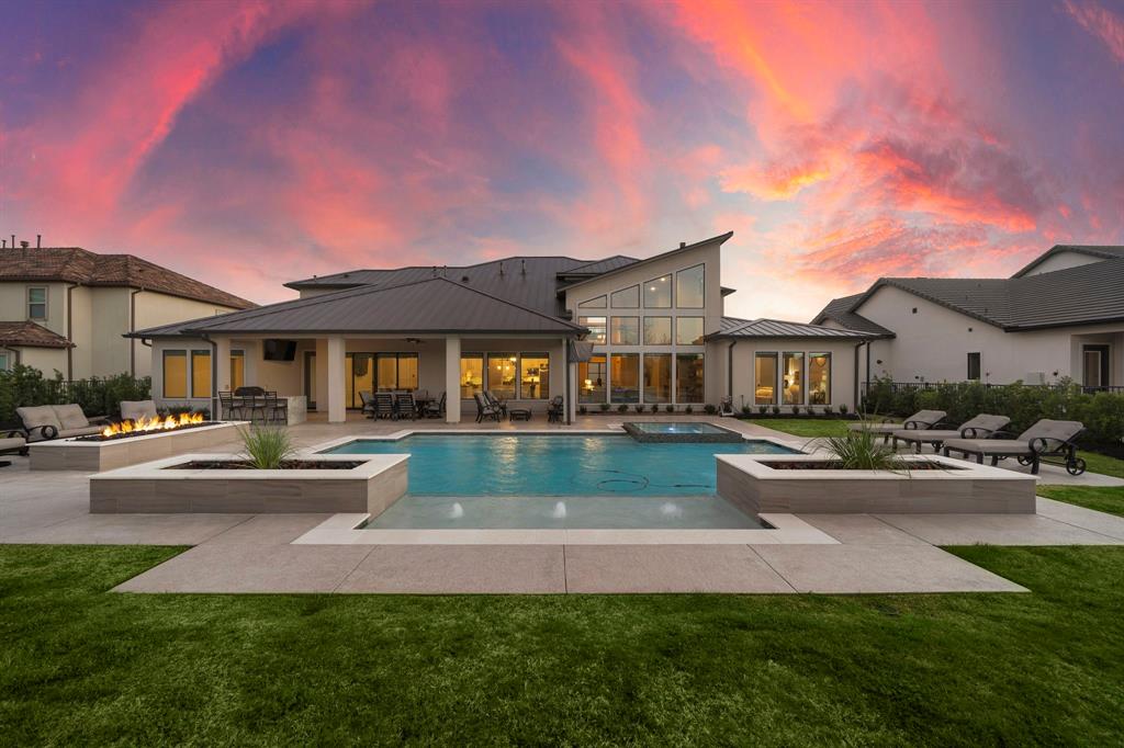 a front view of a house with swimming pool having outdoor seating