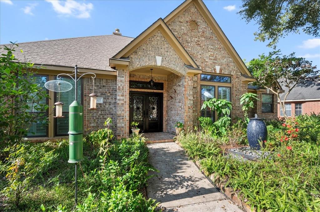 Inviting curb appeal with water feature as you walk into the home!