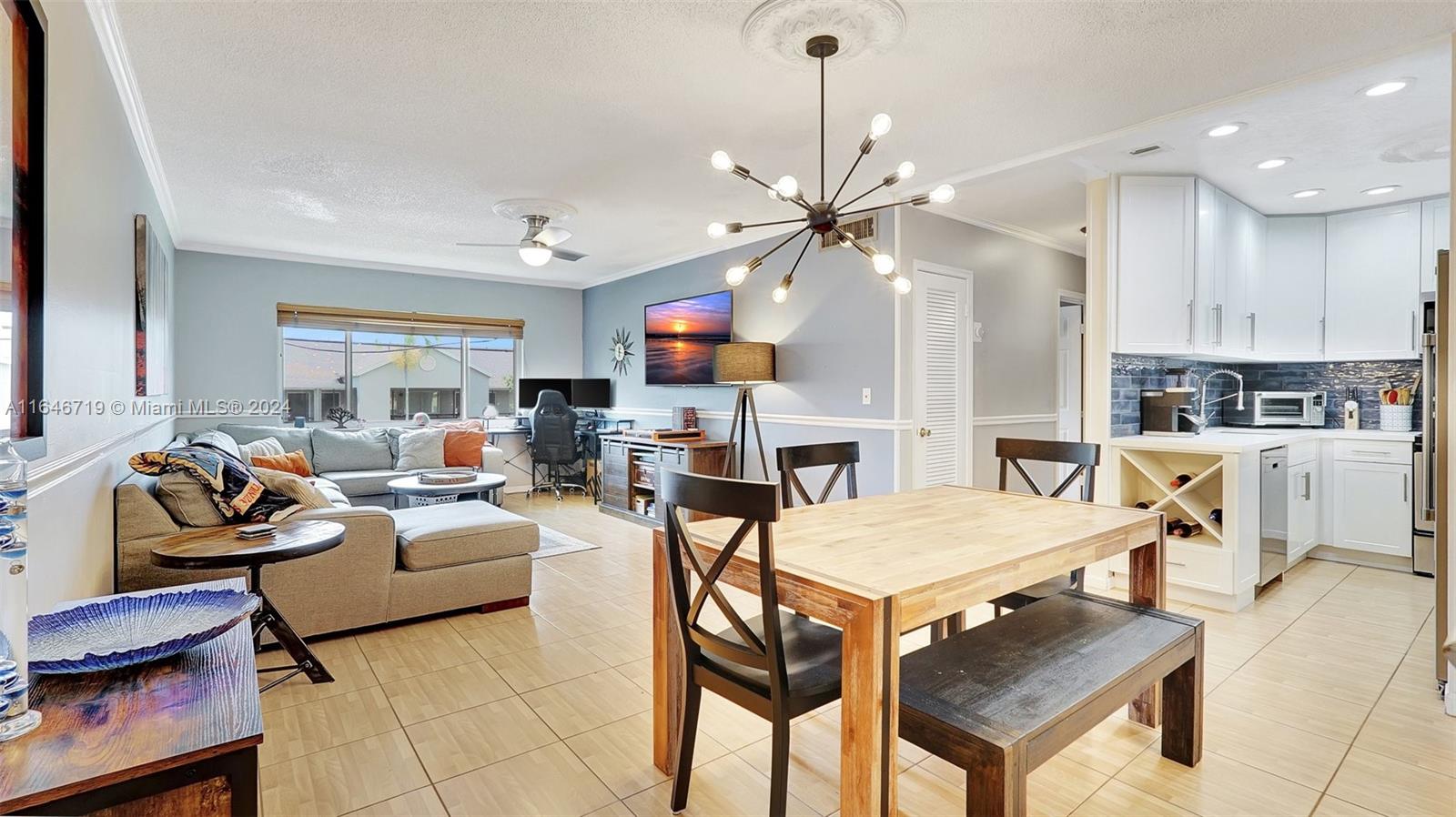 a living room with furniture a fireplace and kitchen view