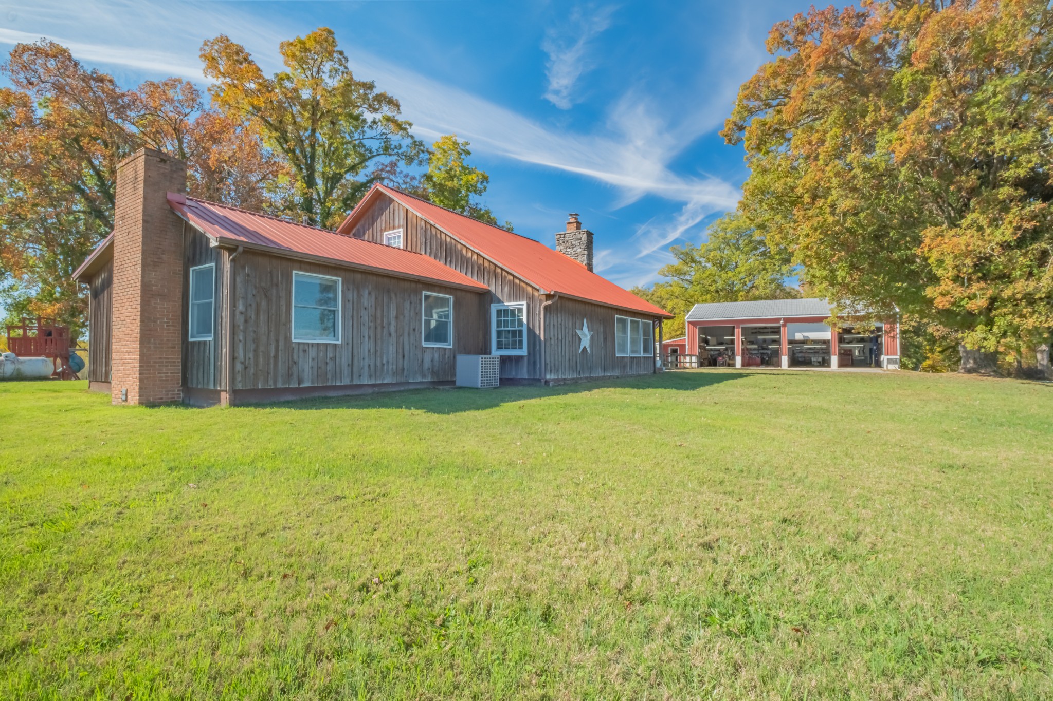 a front view of house with yard and green space