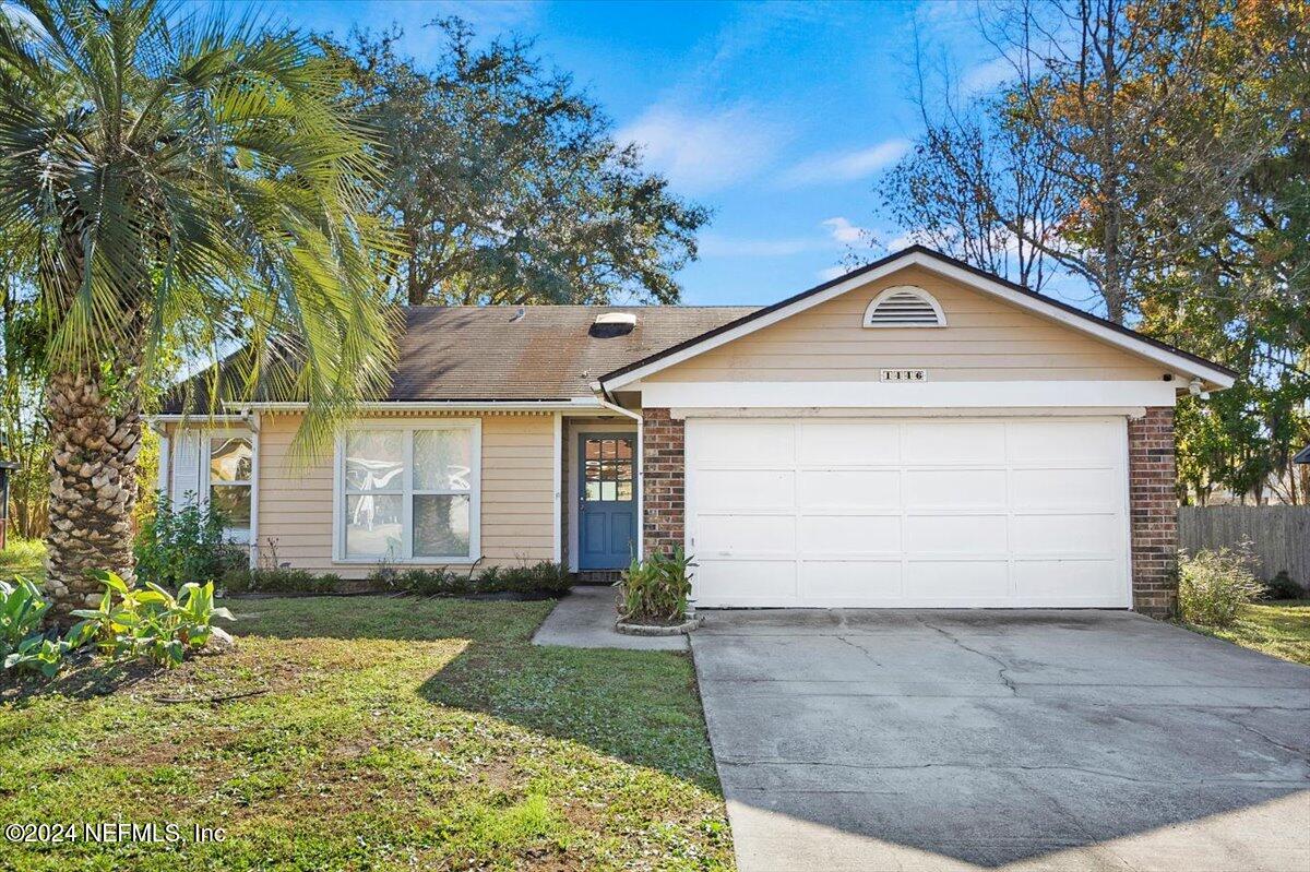 a front view of a house with a yard and garage