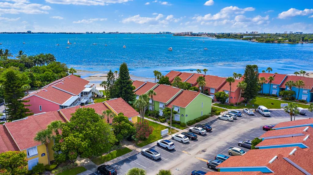 an aerial view of residential houses with outdoor space and ocean view