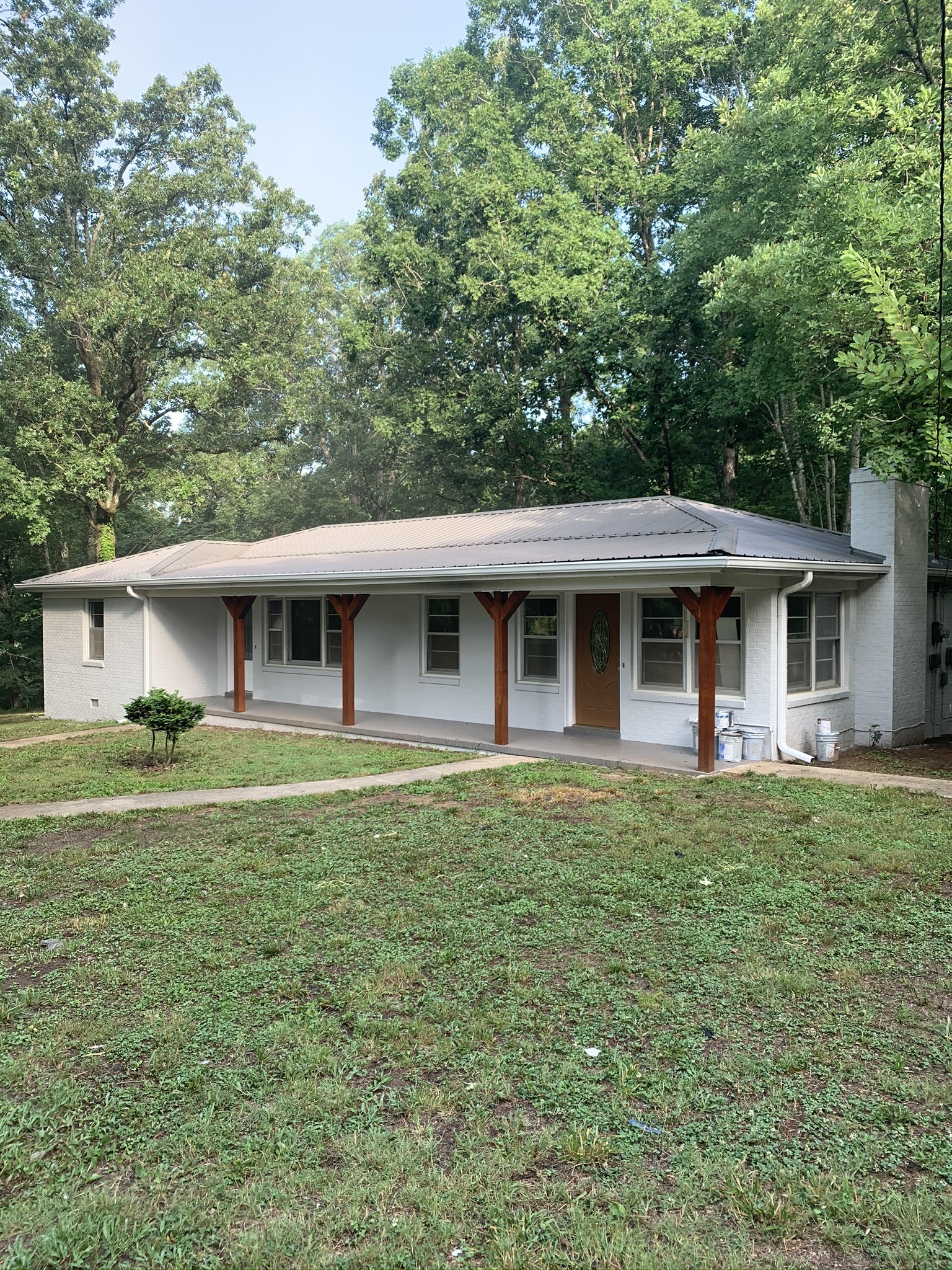 a front view of a house with a garden