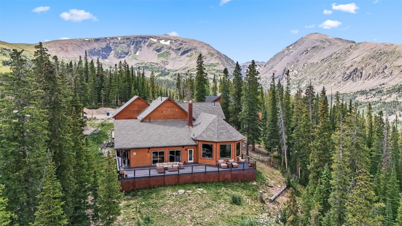 an aerial view of a house with a big yard and large trees