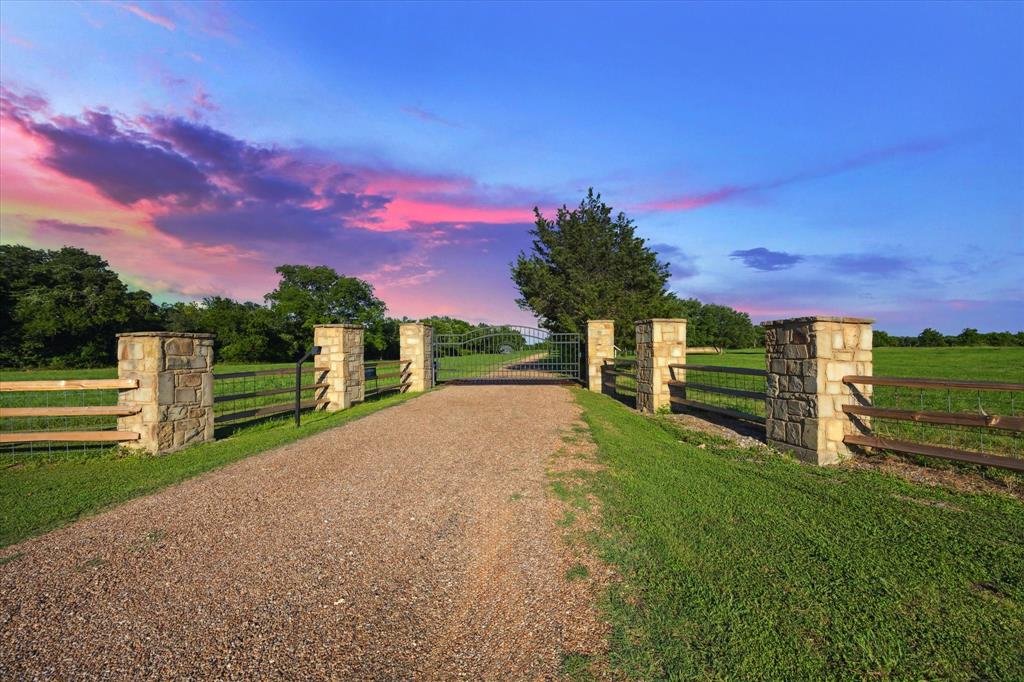 a view of a field with wooden fence