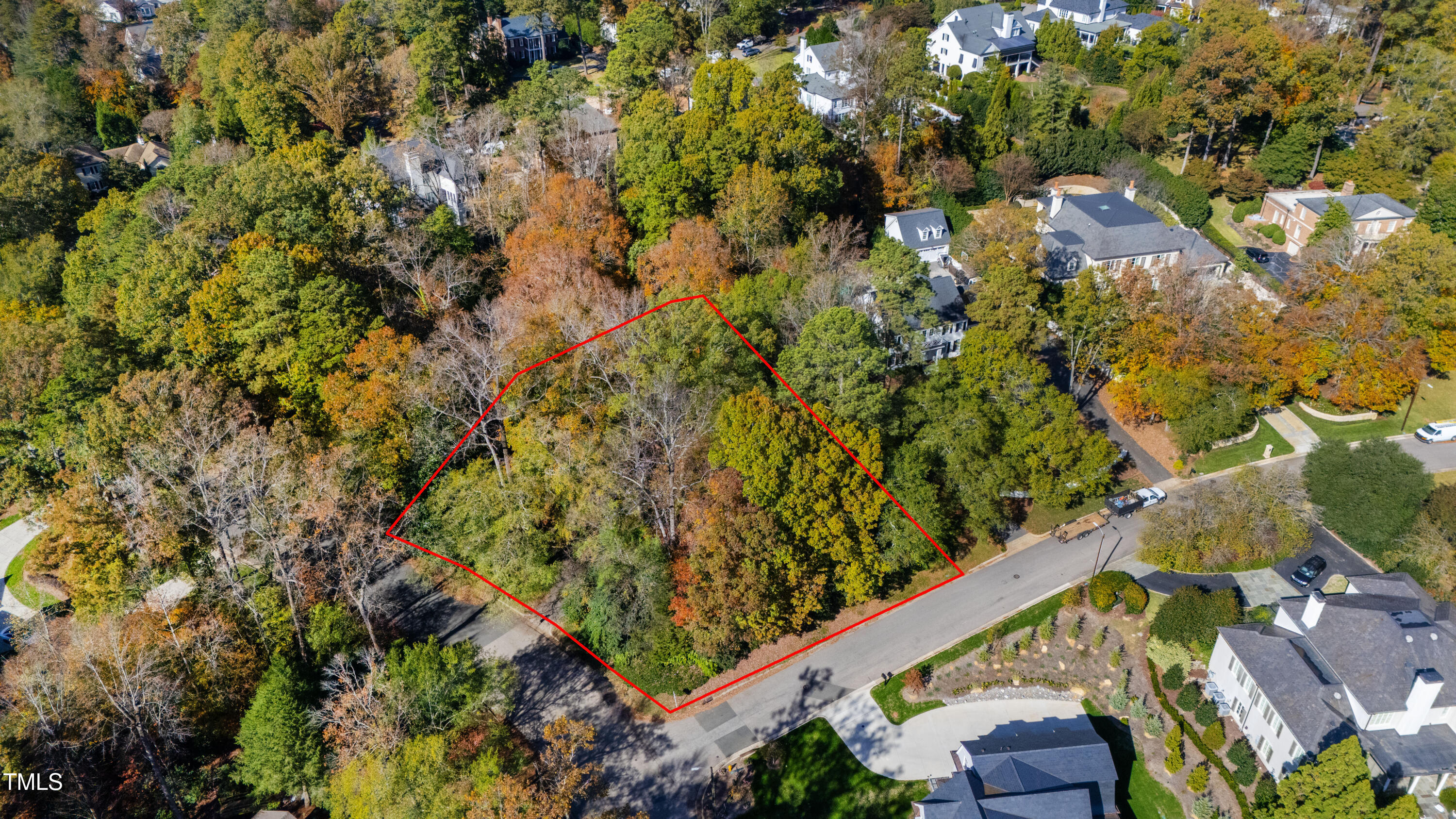 an aerial view of a residential houses with yard