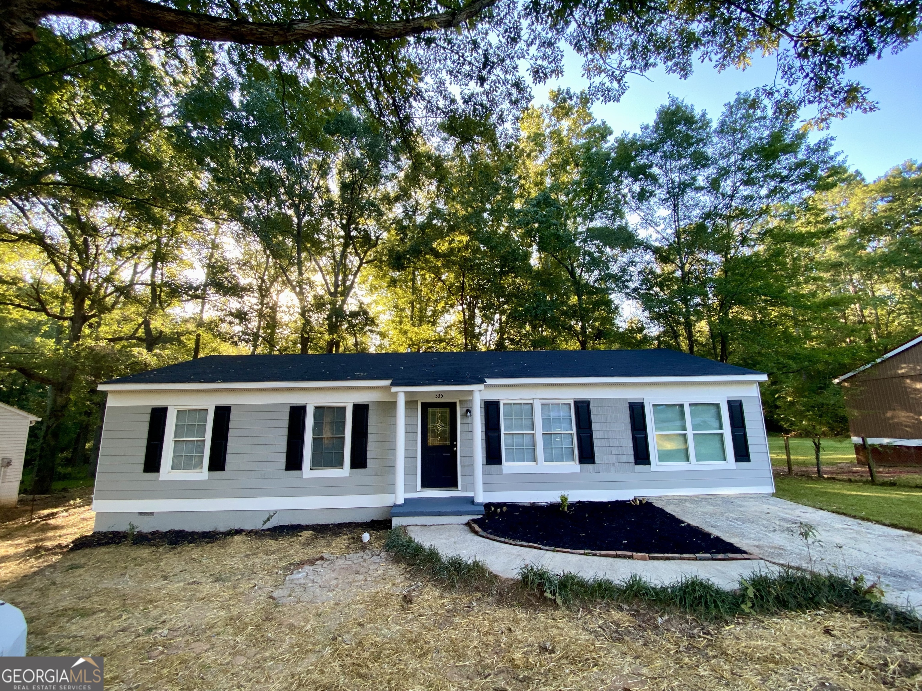 a front view of a house with a garden