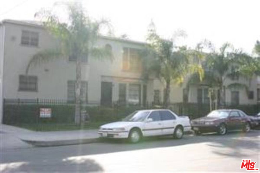 a couple of cars parked in front of a building