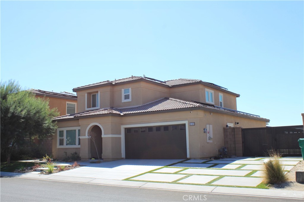 a front view of a house with a big yard and a garage