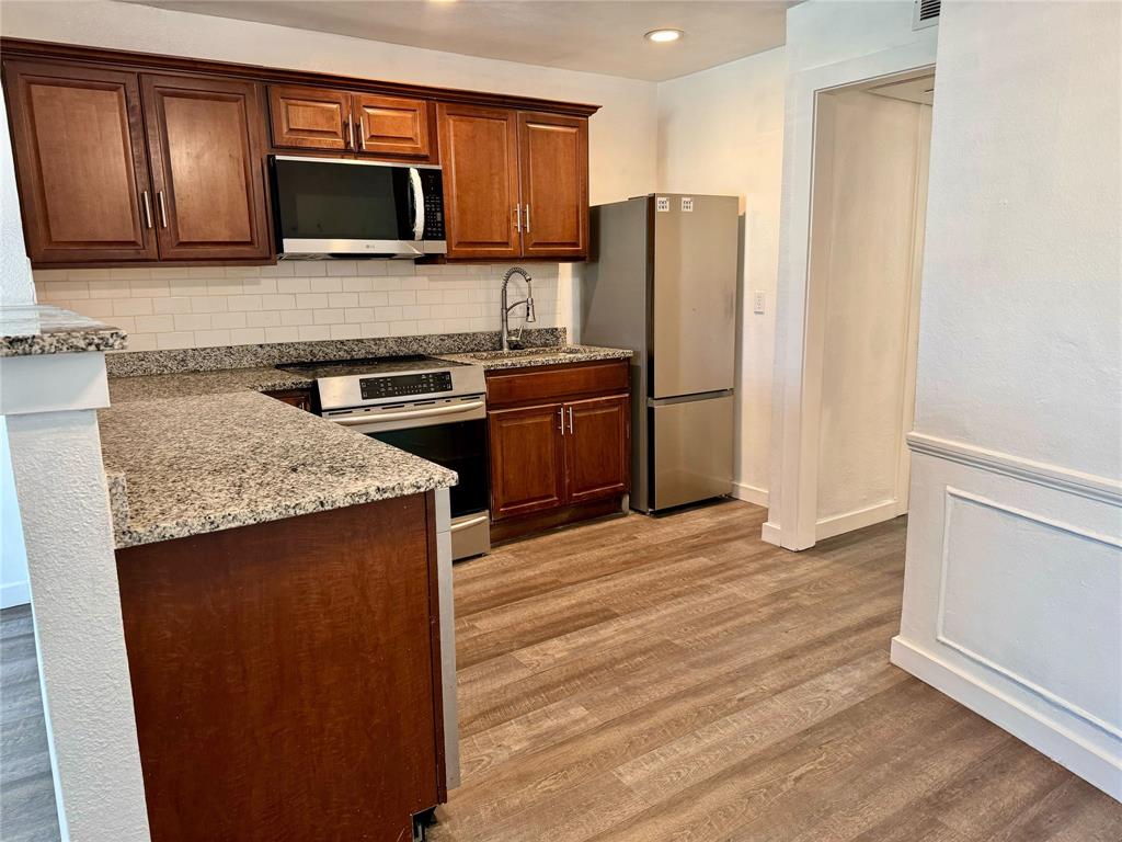 a kitchen with a refrigerator stove and microwave