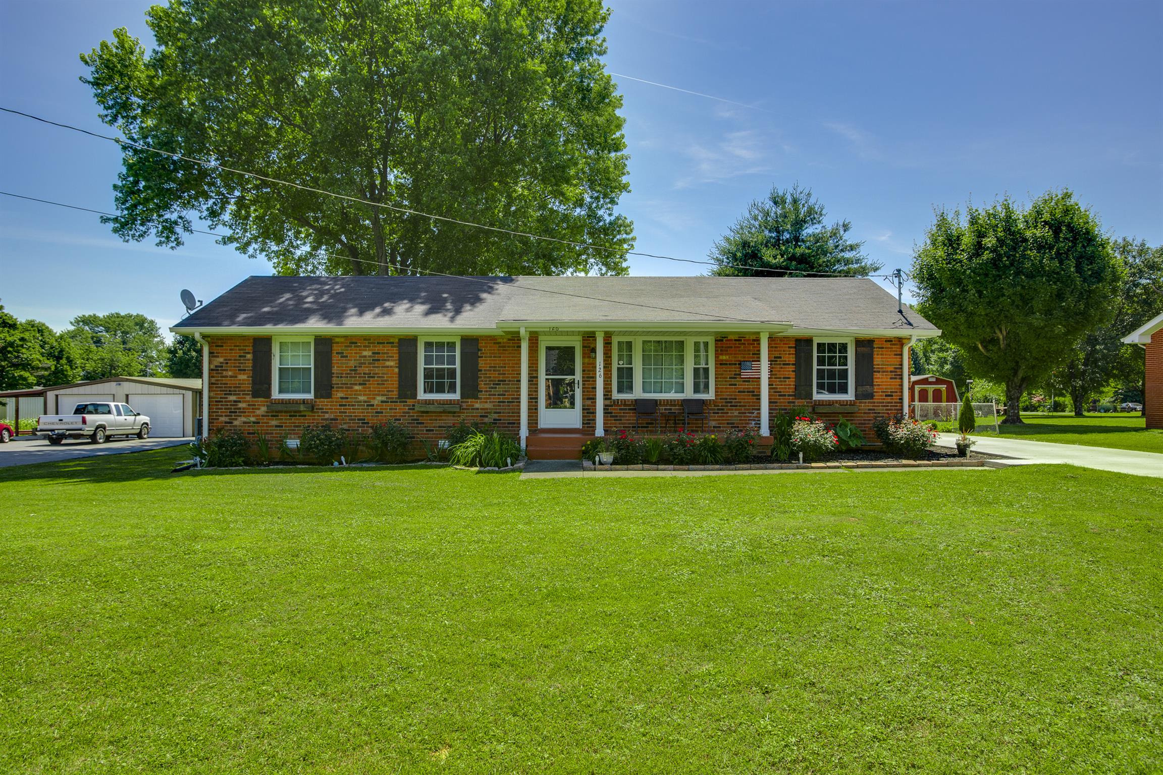 a front view of a house with a garden