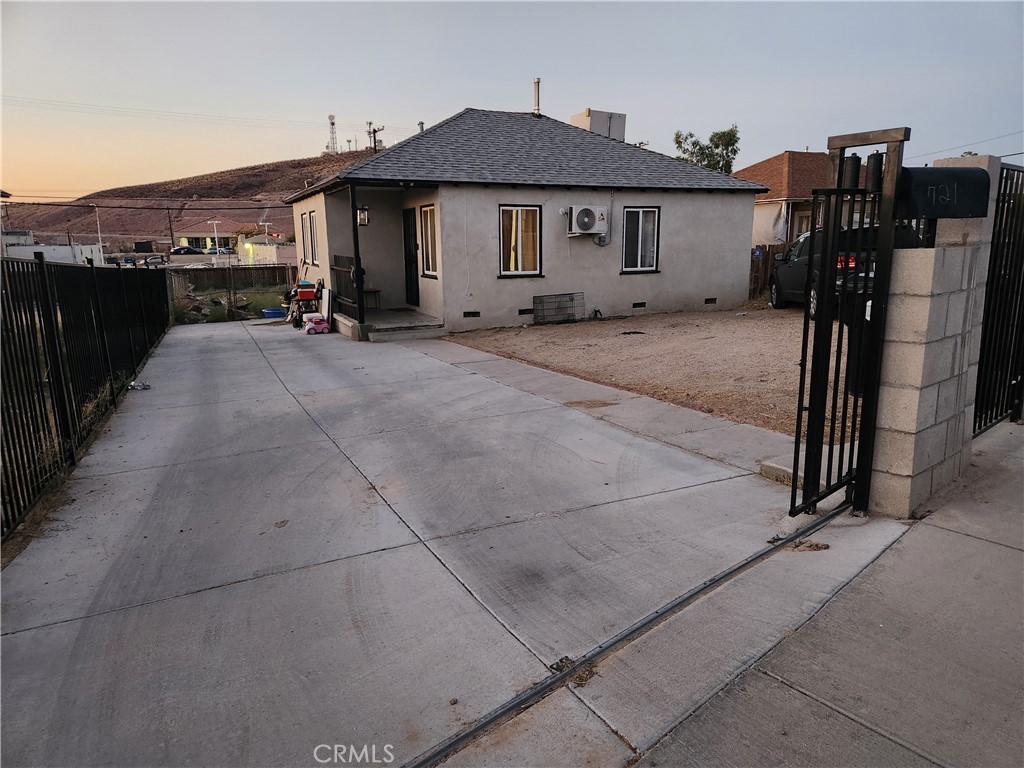 a view of a house with a wooden fence