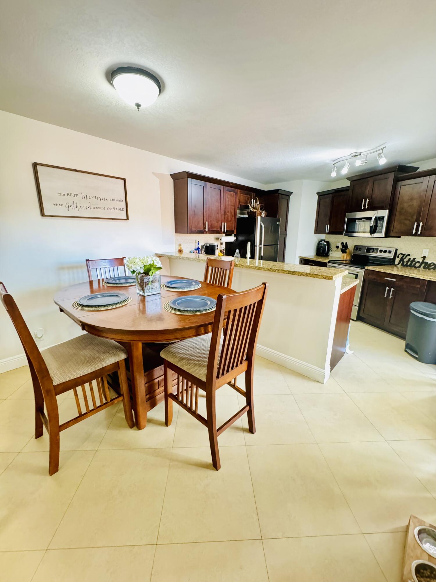 a dining room with furniture and a kitchen view