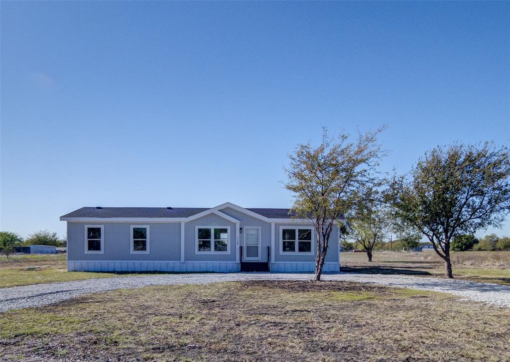 a house that has a tree in front of it