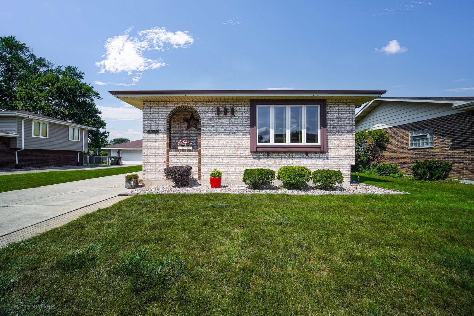 a front view of house with yard and green space