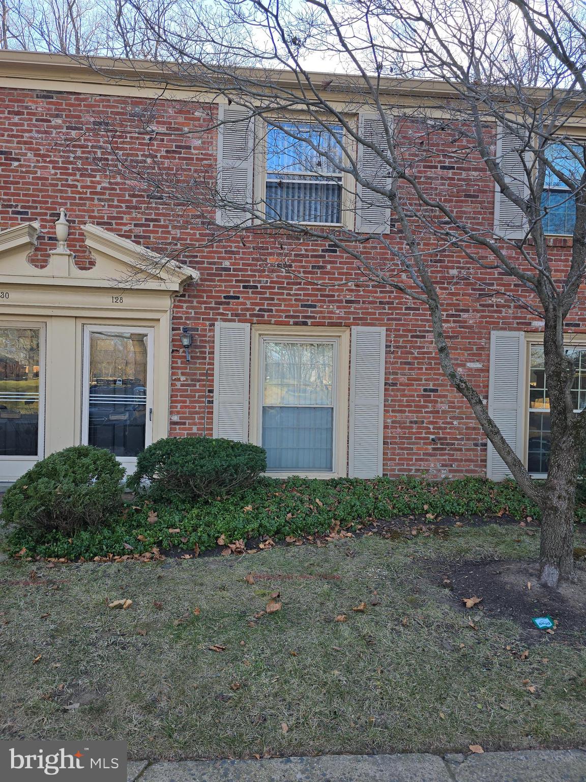 a brick building with a small yard