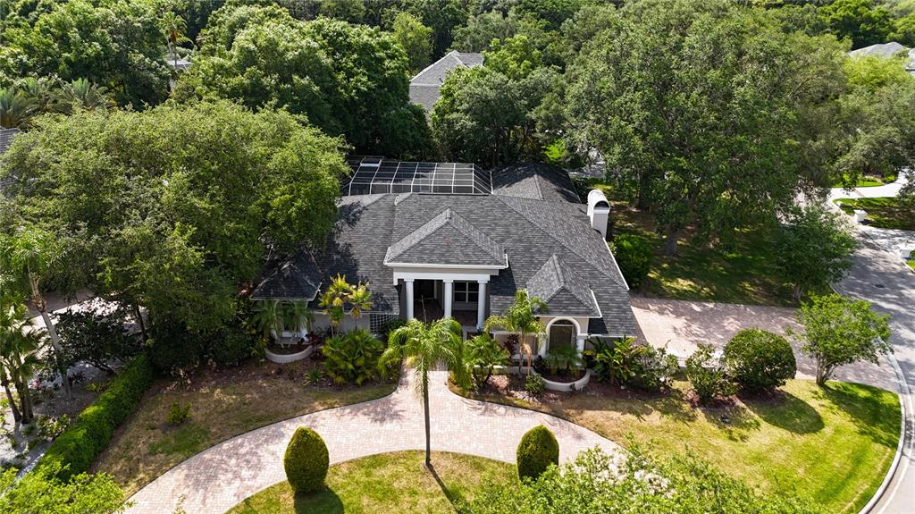 an aerial view of a house with swimming pool and garden