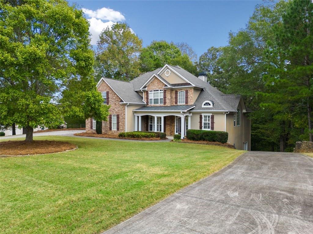 a front view of a house with a garden