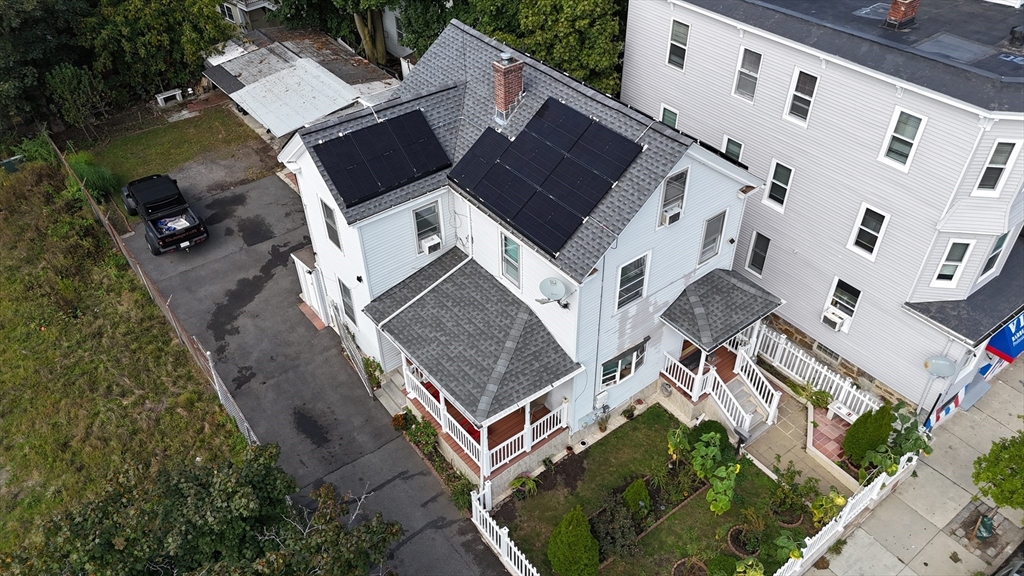 an aerial view of a house with a yard