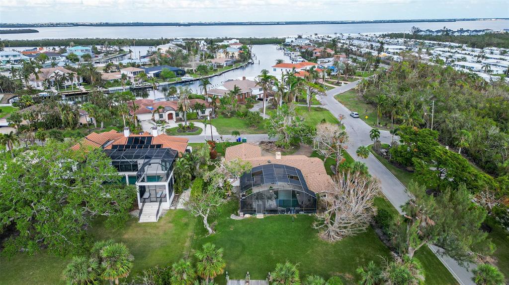 an aerial view of a house with a yard and lake view