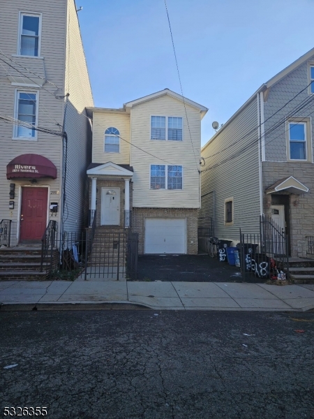 a front view of a house with basket ball court