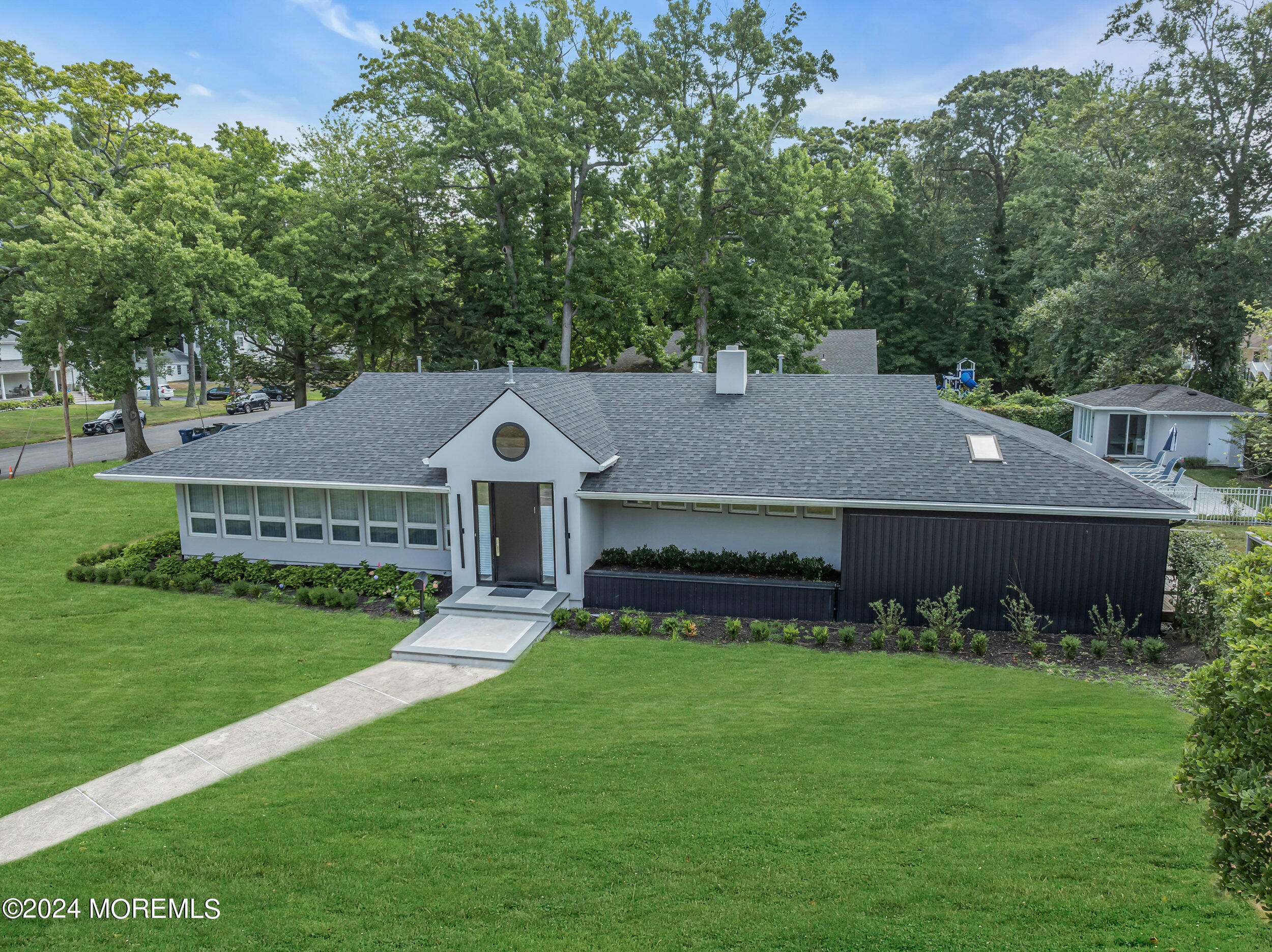 a front view of a house with a garden