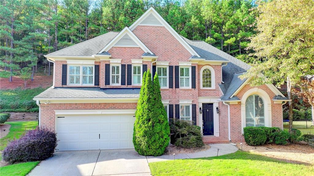 a front view of a house with a yard and garage